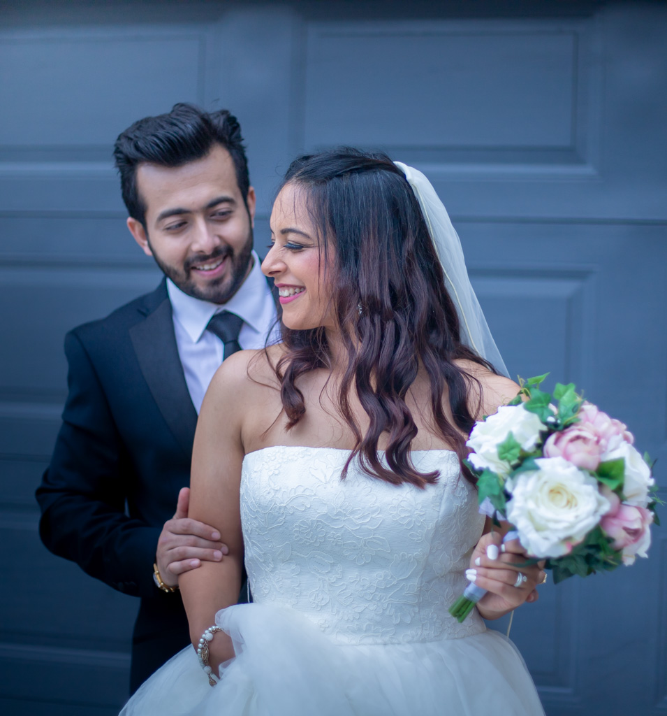 Auckland wedding photographer — couple laughing at wedding portrait