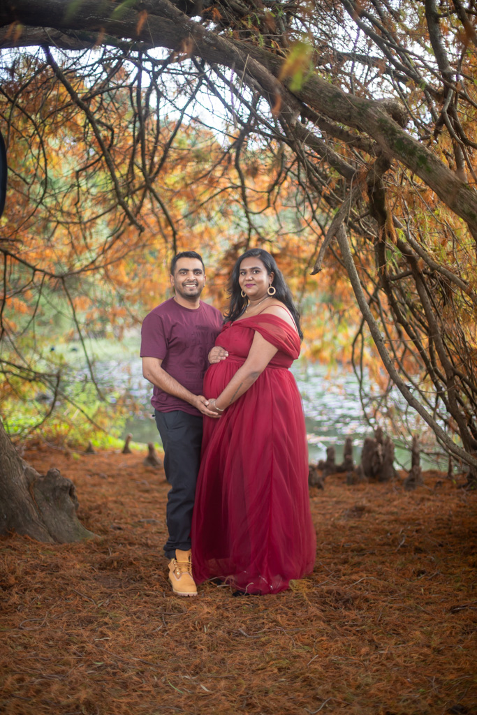 Auckland maternity photographer — couple in autumn foliage