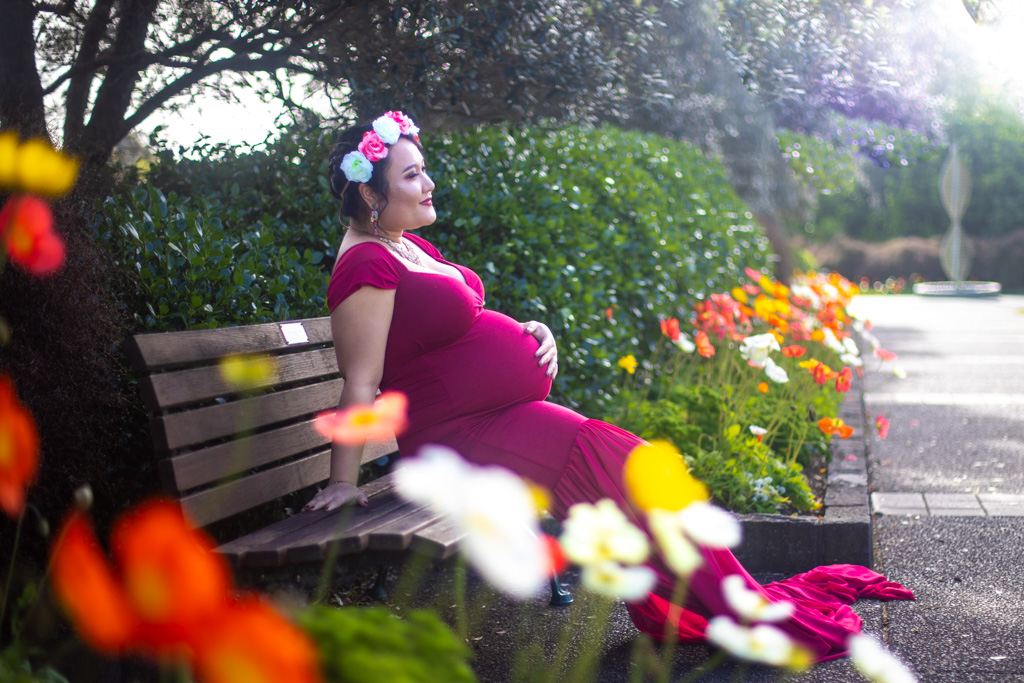 Auckland maternity photographer — garden bench with colourful flowers